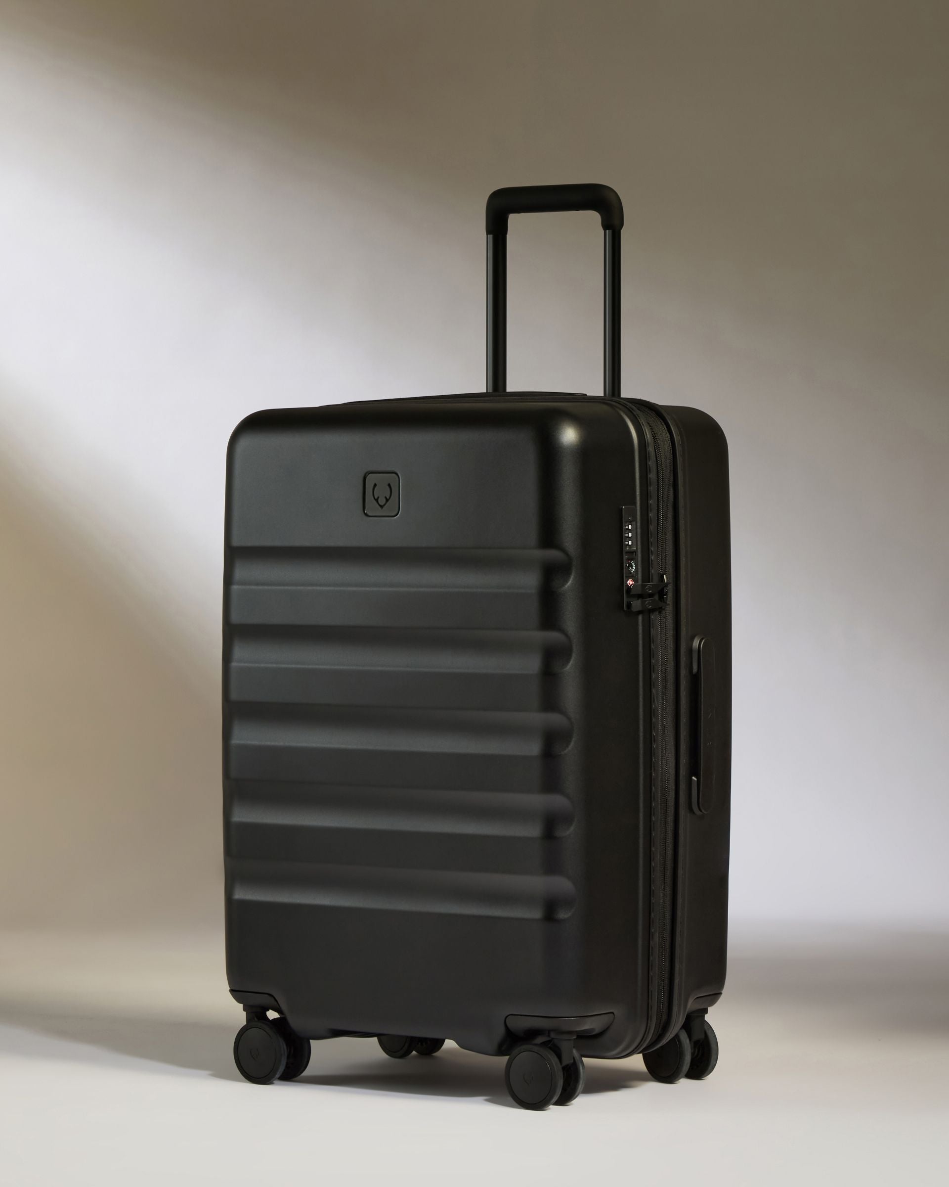 Black suitcase on a light gray background