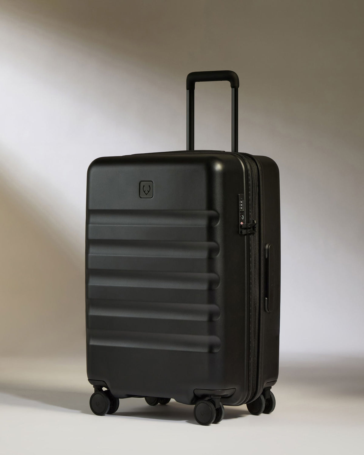 Black suitcase on a light gray background