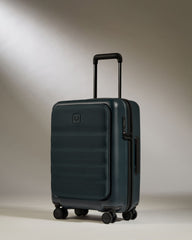 Dark green suitcase with a handle and wheels on a neutral background
