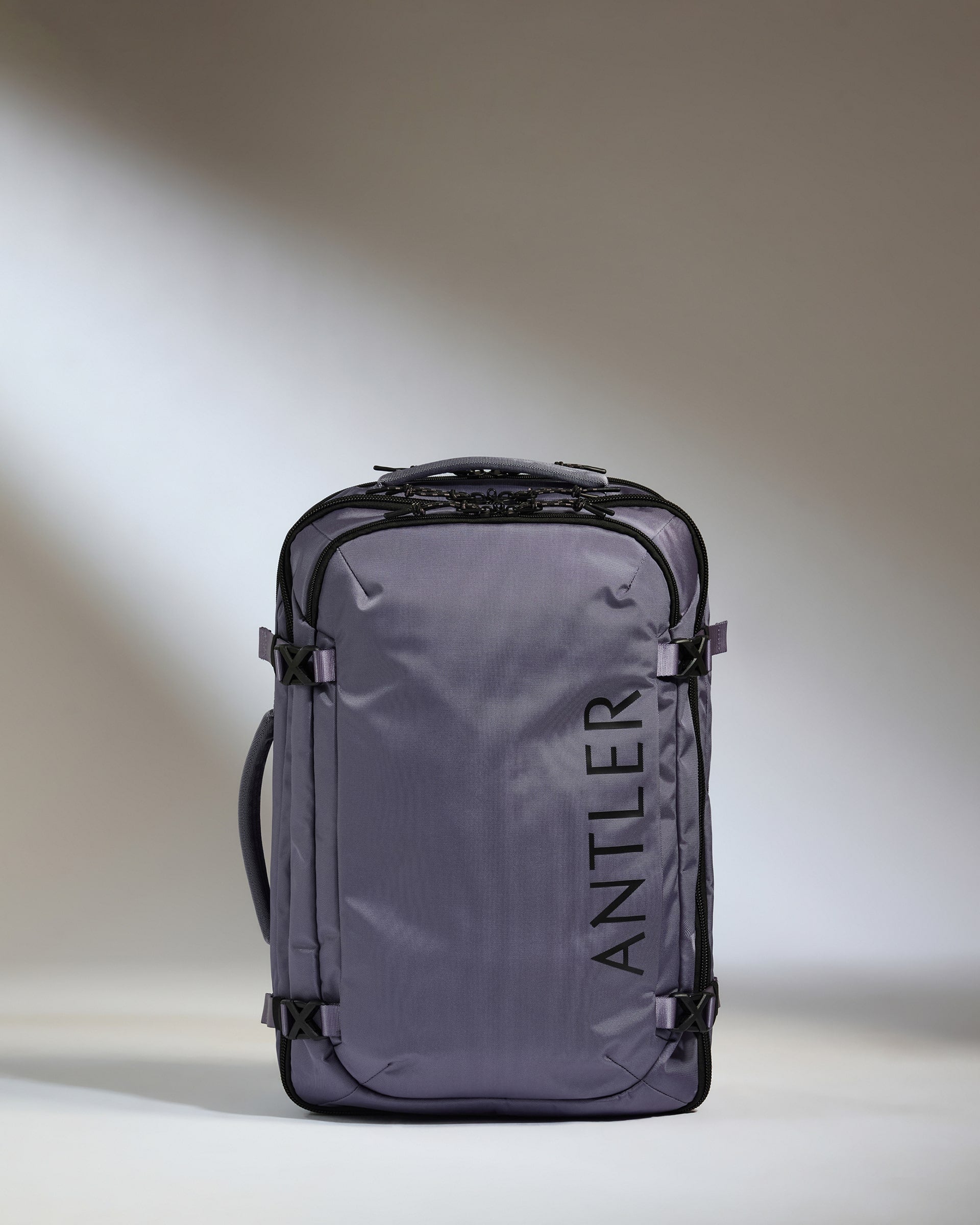 Gray travel backpack with 'Antler' branding on a light background