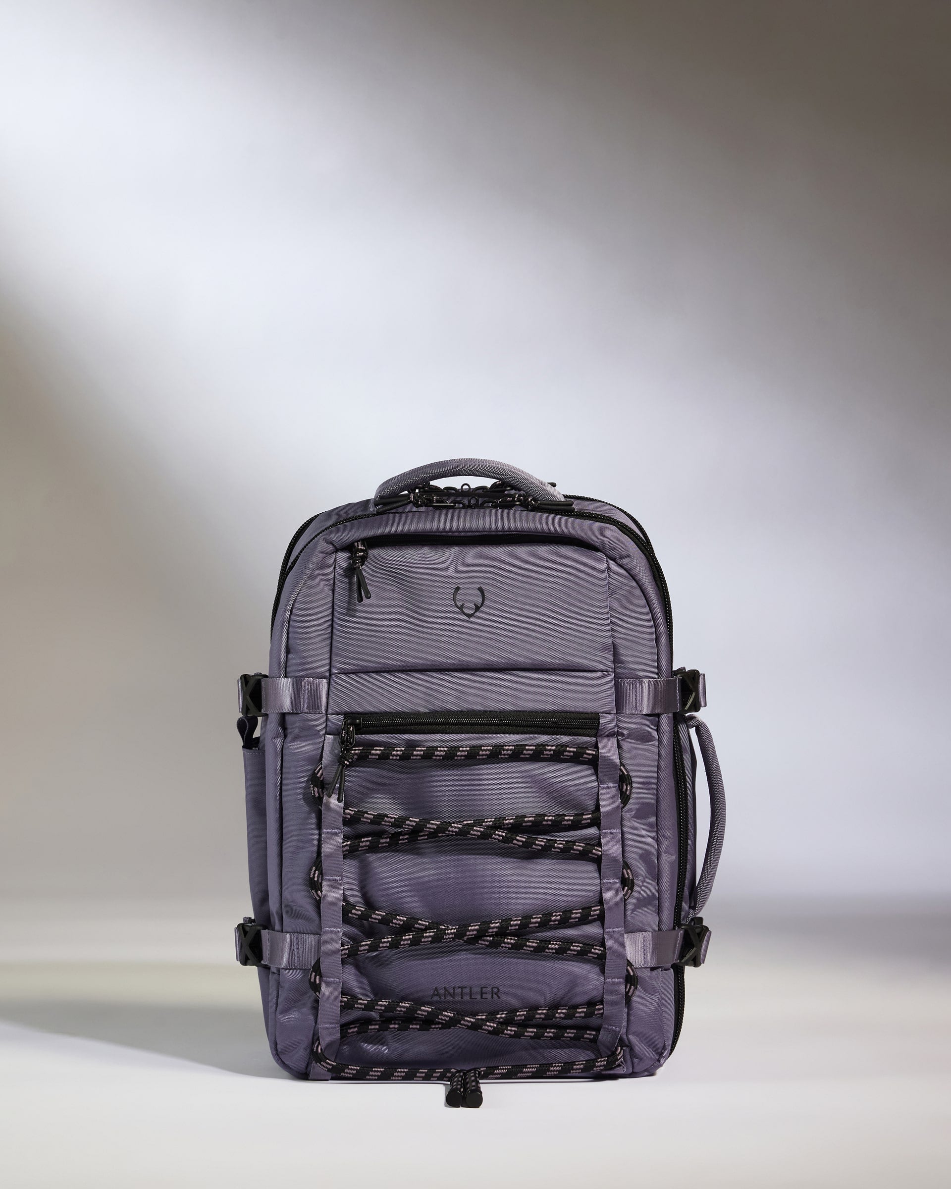 Gray backpack with multiple compartments on a light gray background