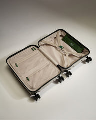 Open suitcase with green interior on a light background