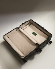 Open suitcase with beige interior on a light gray background
