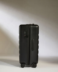 Black suitcase on a light gray background