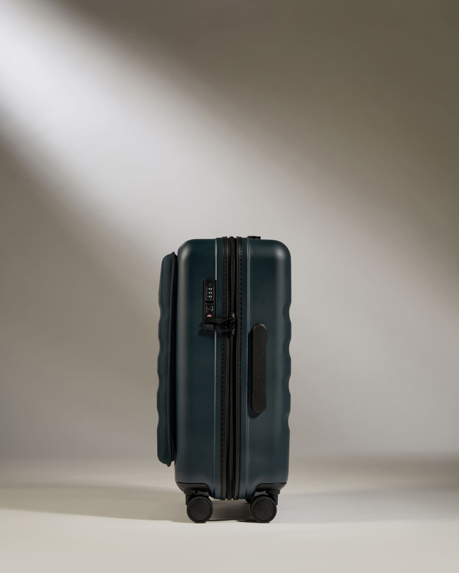 Green suitcase on a light gray background