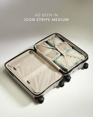 Open suitcase with packing cubes on a light background