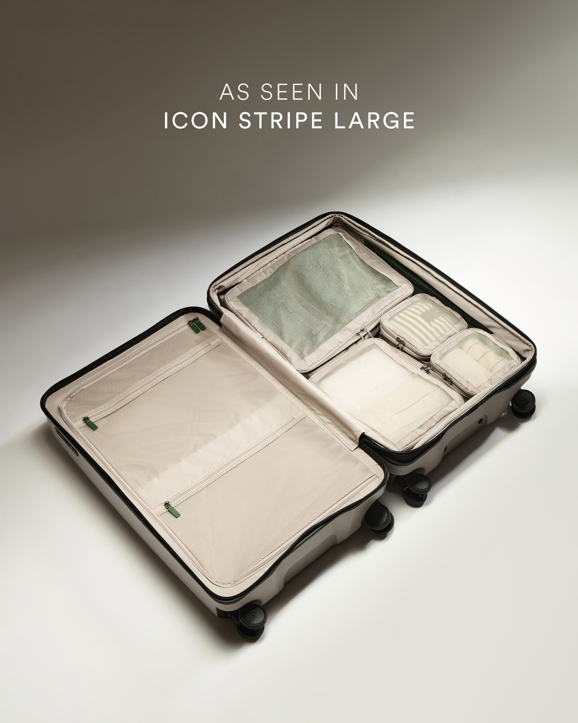 Open suitcase with packing cubes on a neutral background