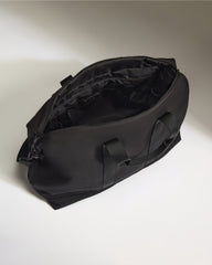 Black duffel bag on a light gray background