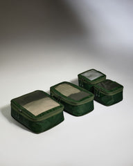 Set of green packing cubes on a gray background