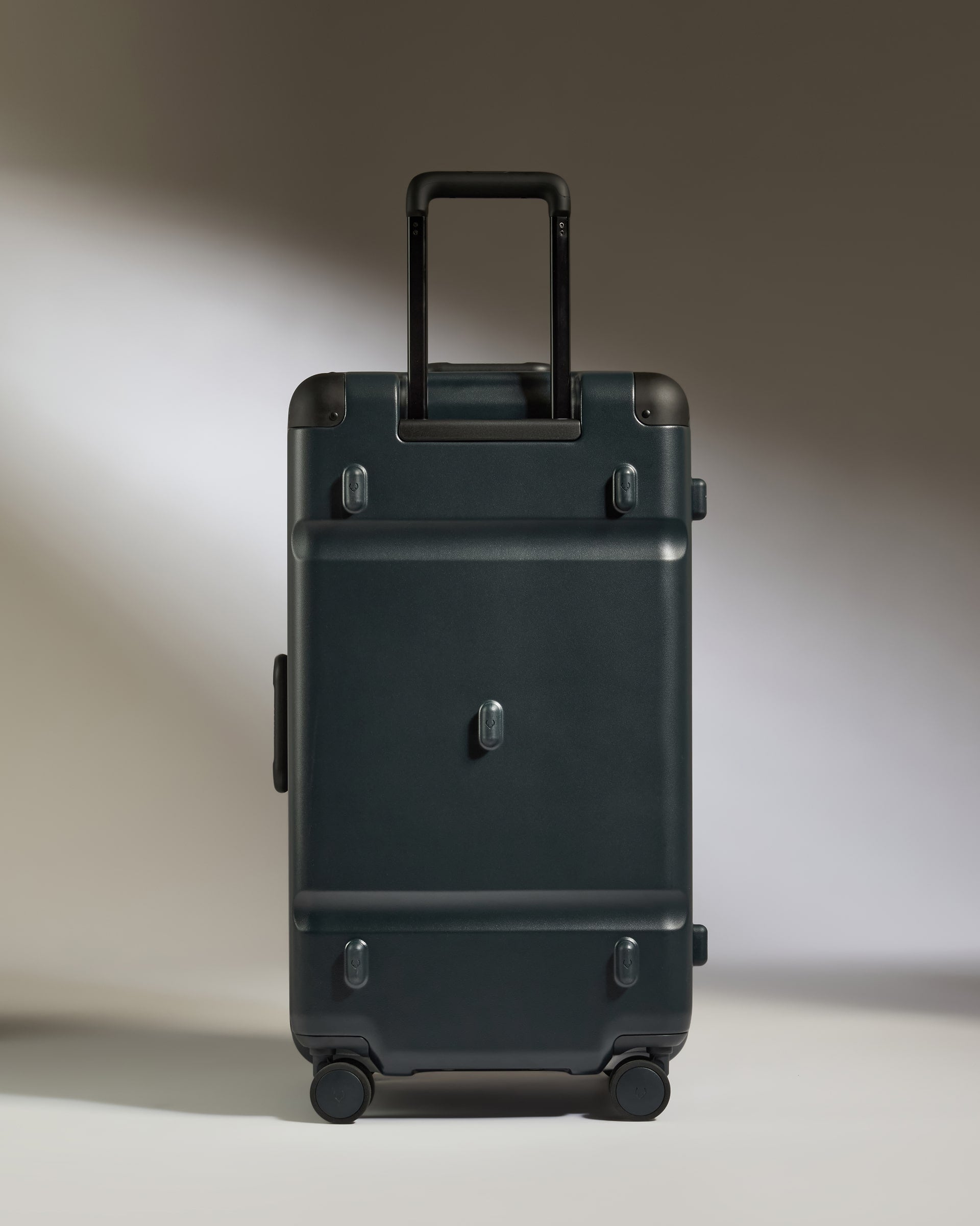 Black suitcase on a neutral background