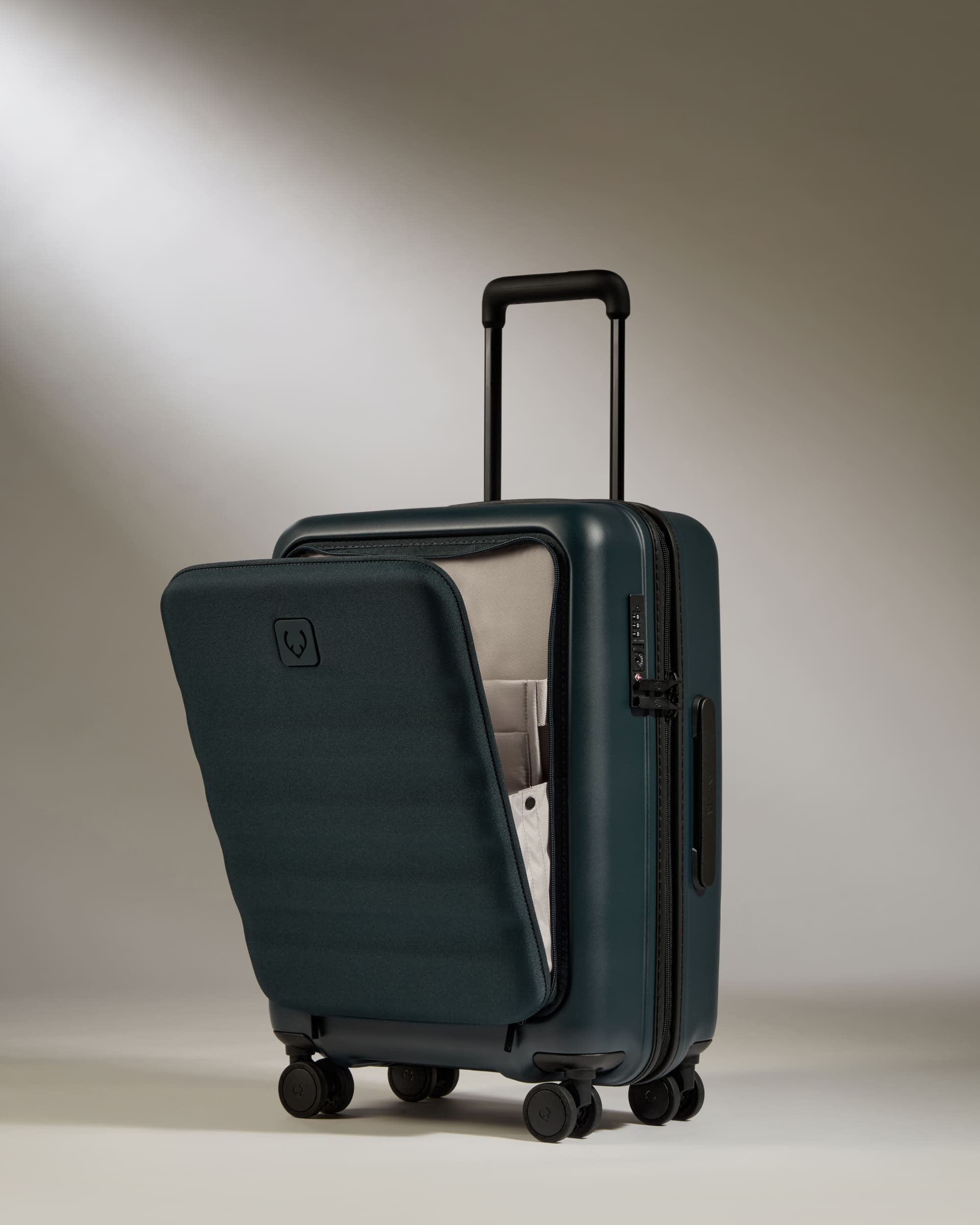 Green suitcase with open door on a neutral background