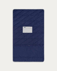 Navy quilted cover with a brand label on a light gray background