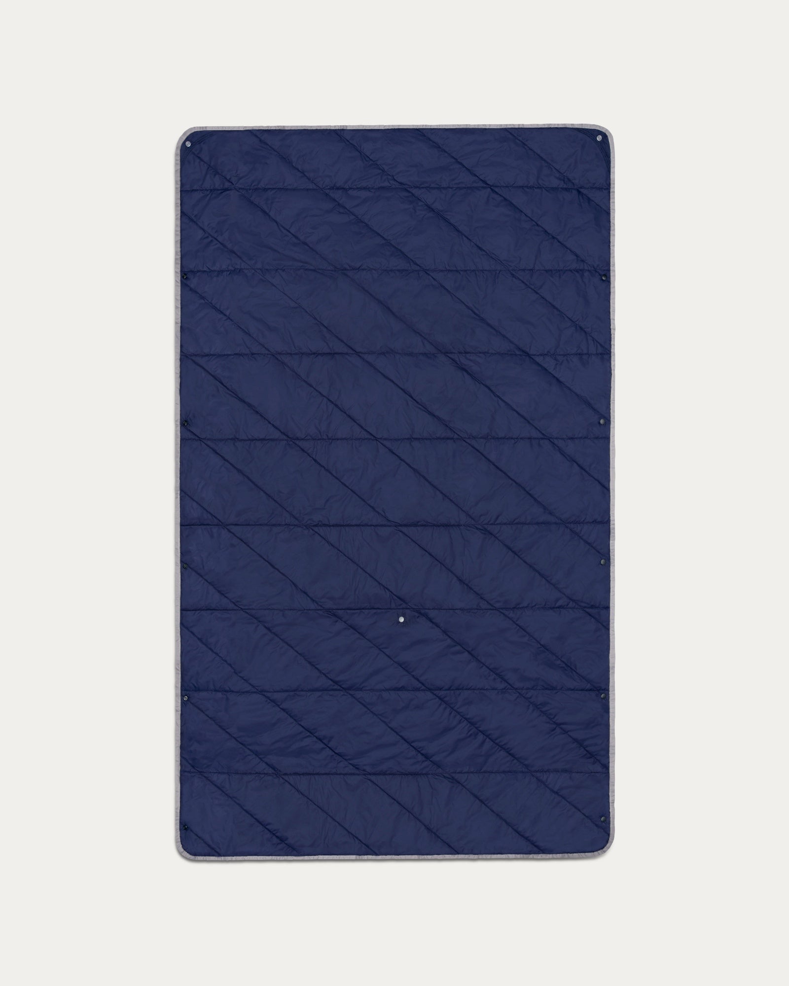 Blue quilted mat on a light gray background