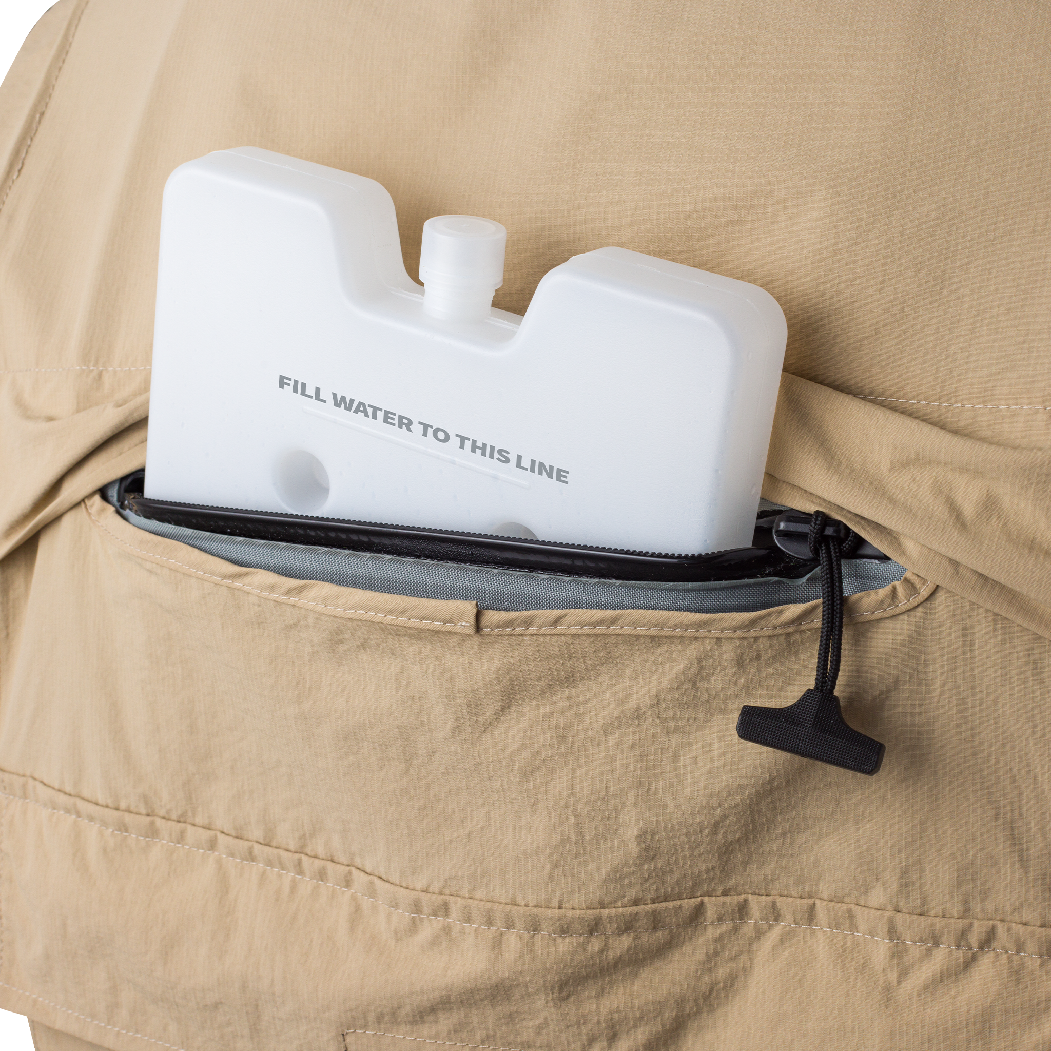 Collapsible water bottle with 'Fill water to this line' text in a beige jacket pocket.