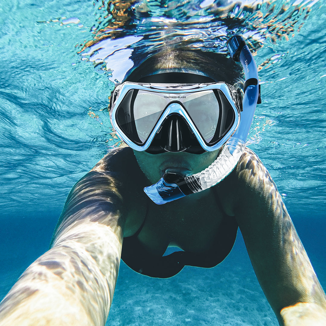 Person snorkeling underwater wearing a mask and snorkel