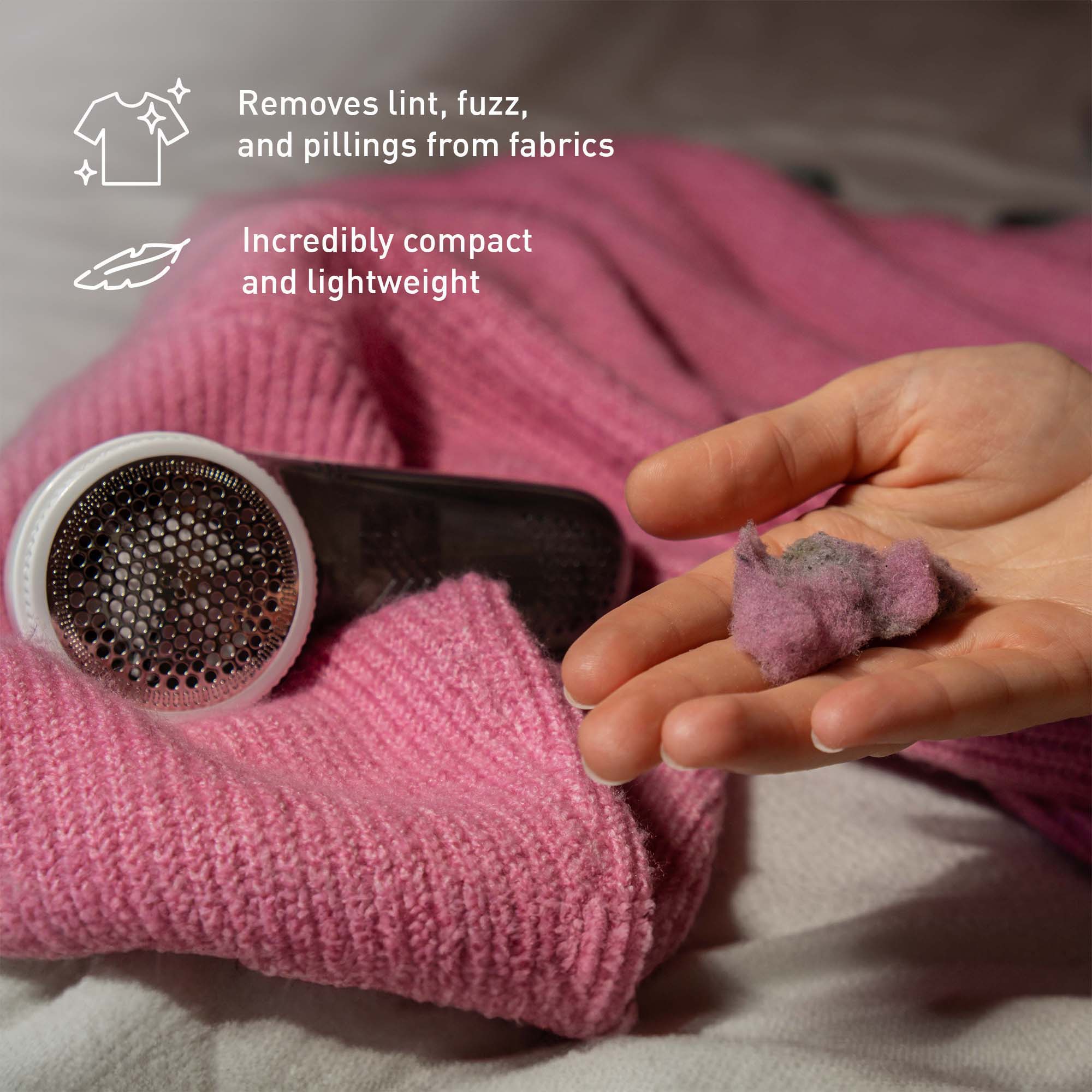 Handheld cleaning tool removing lint from a pink sweater with text highlighting features.