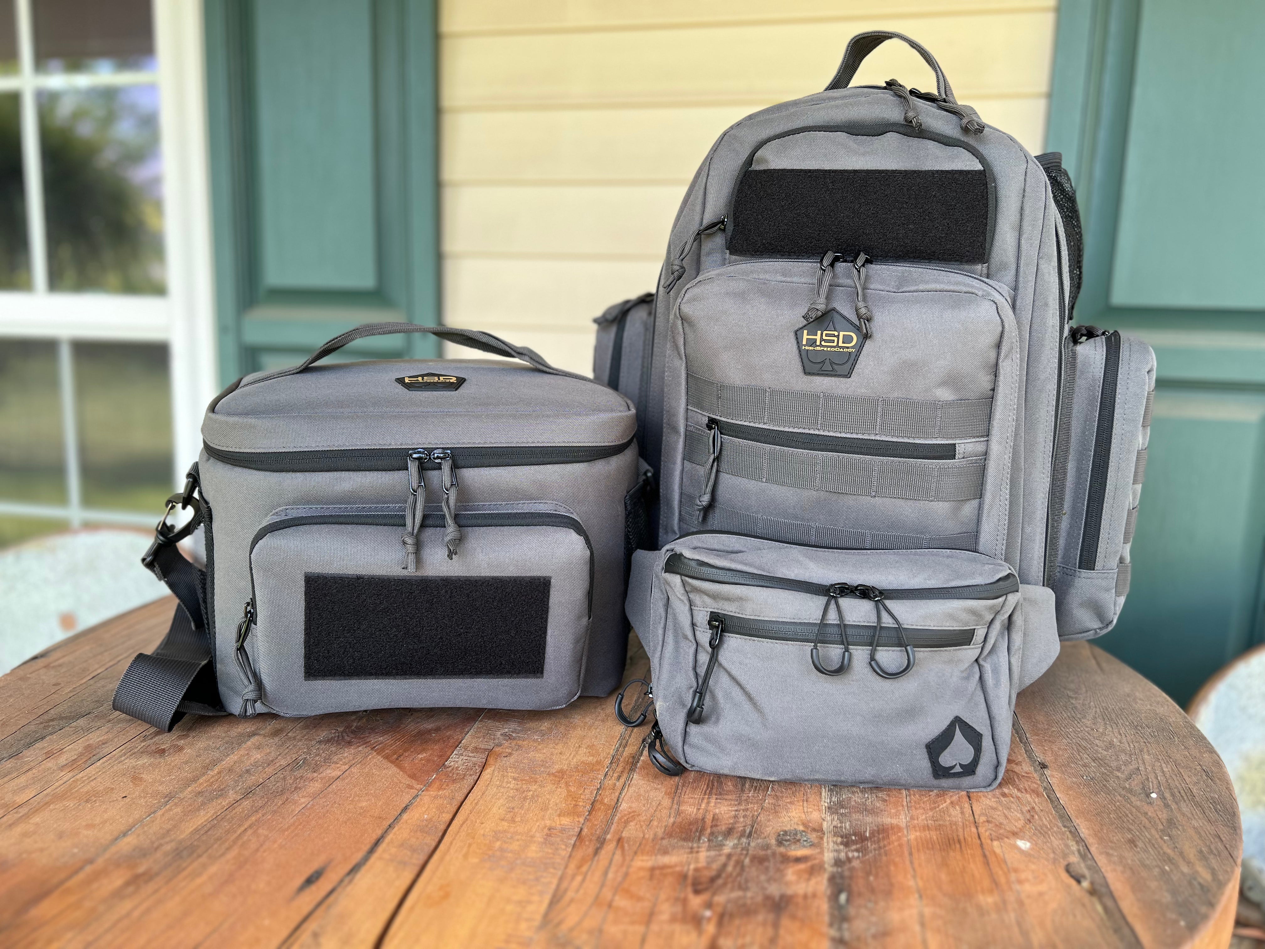 Two gray backpacks with black accents on a wooden surface.