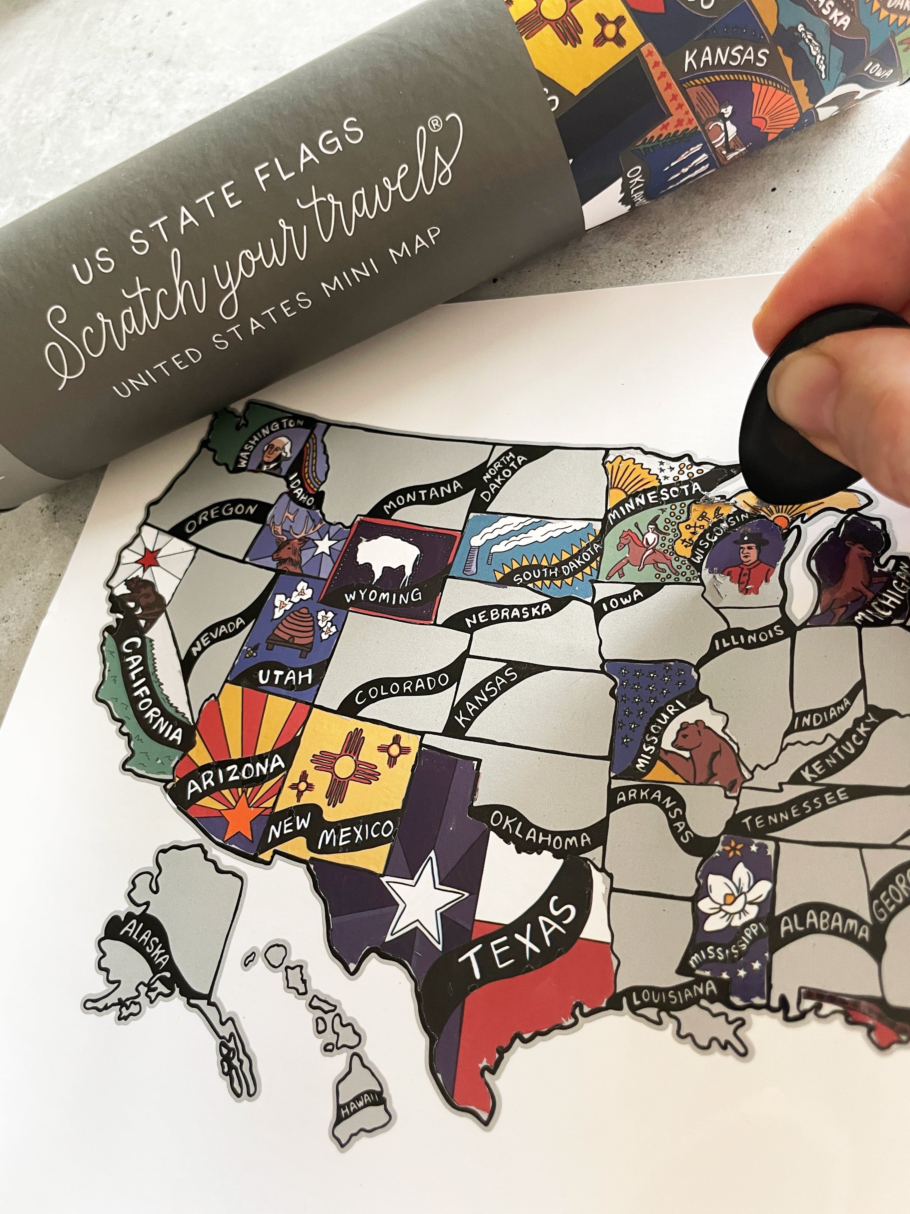Map of the United States with state flags and a scratch-off travel map.