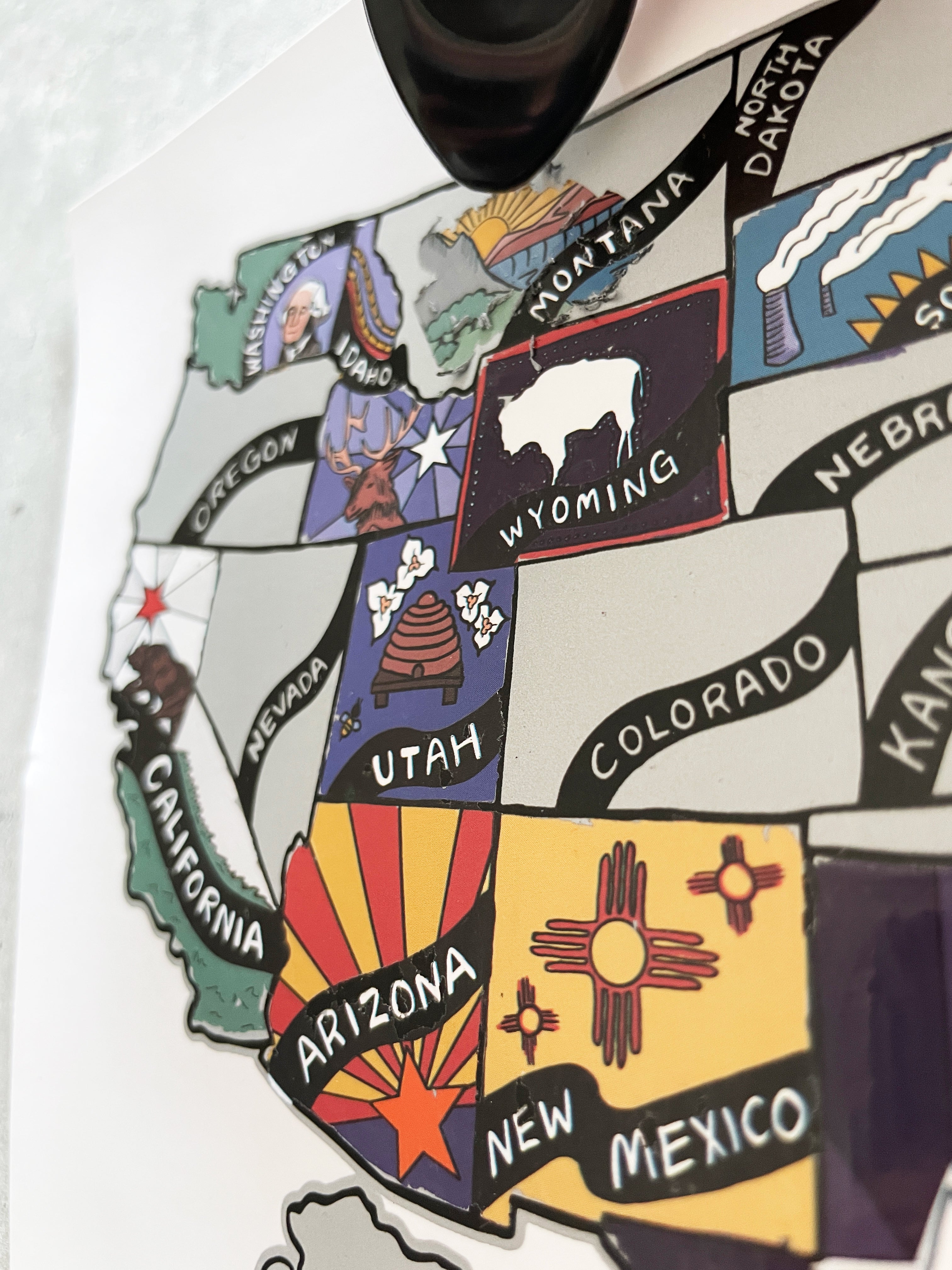 Map of the United States with state symbols on a white shirt