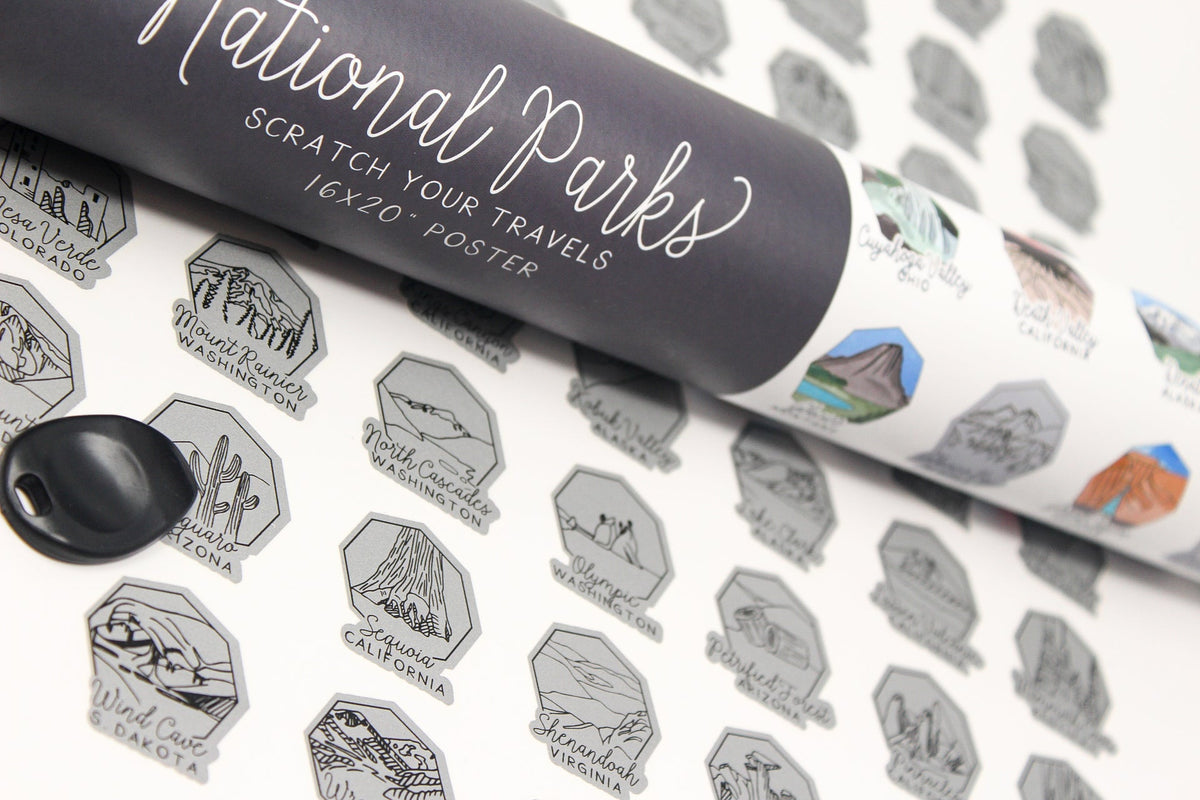 Roll of 'National Parks' scratch-off poster with black and white designs on a textured surface.