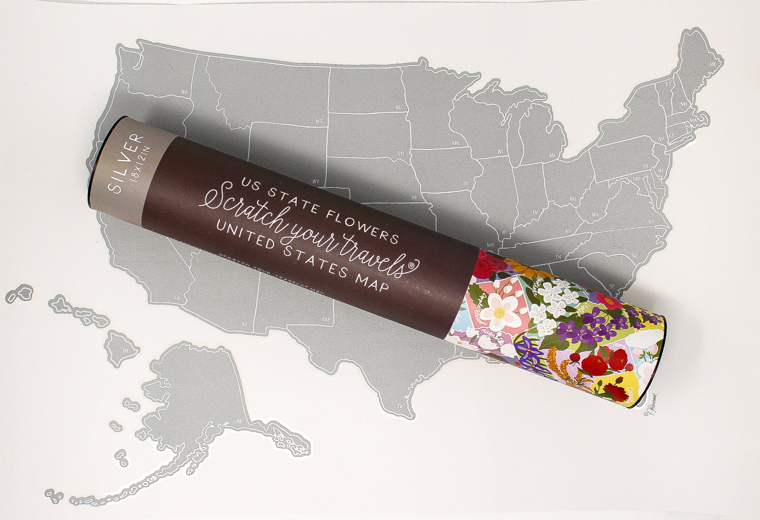 United States map with a scratch-off travel guide book on top