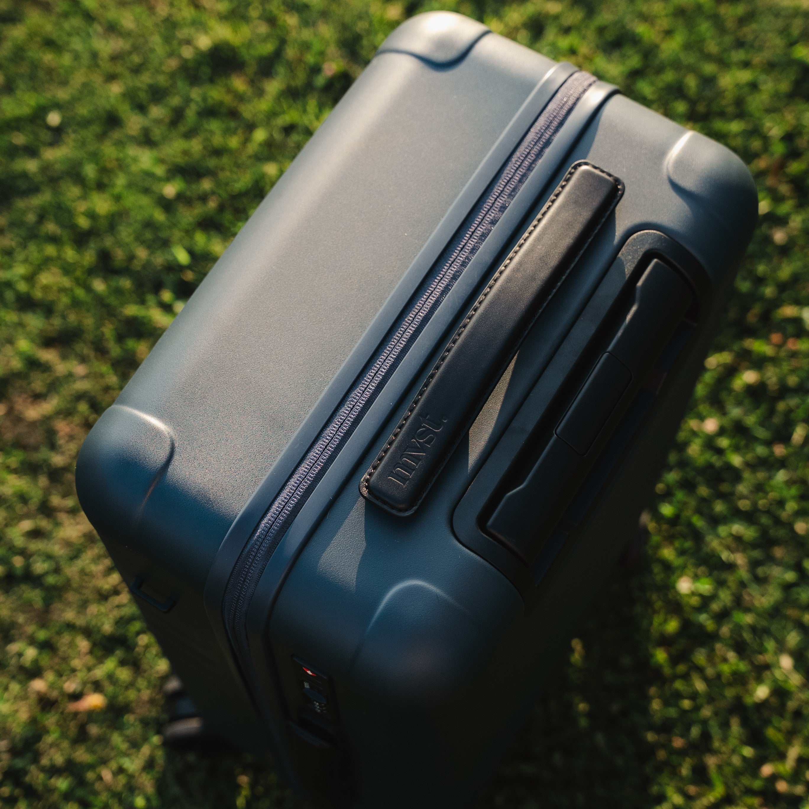 Blue suitcase on grass