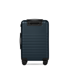 Blue suitcase with black handle and wheels on a white background
