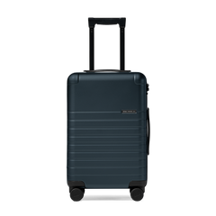 Dark blue suitcase with a visible brand logo on a white background