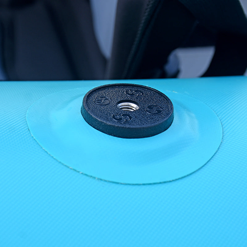 Black suction cup on a blue surface with a blurred background
