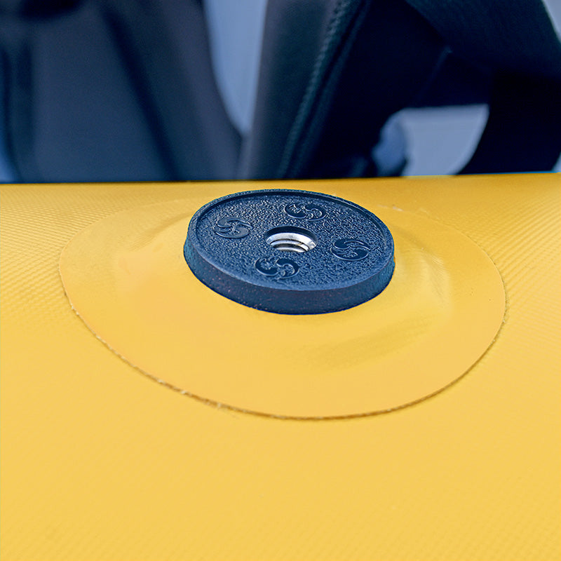 Close-up of a blue weight plate on a yellow exercise ball