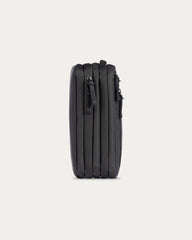 A black hard-shell suitcase shown from the side against a light gray background.