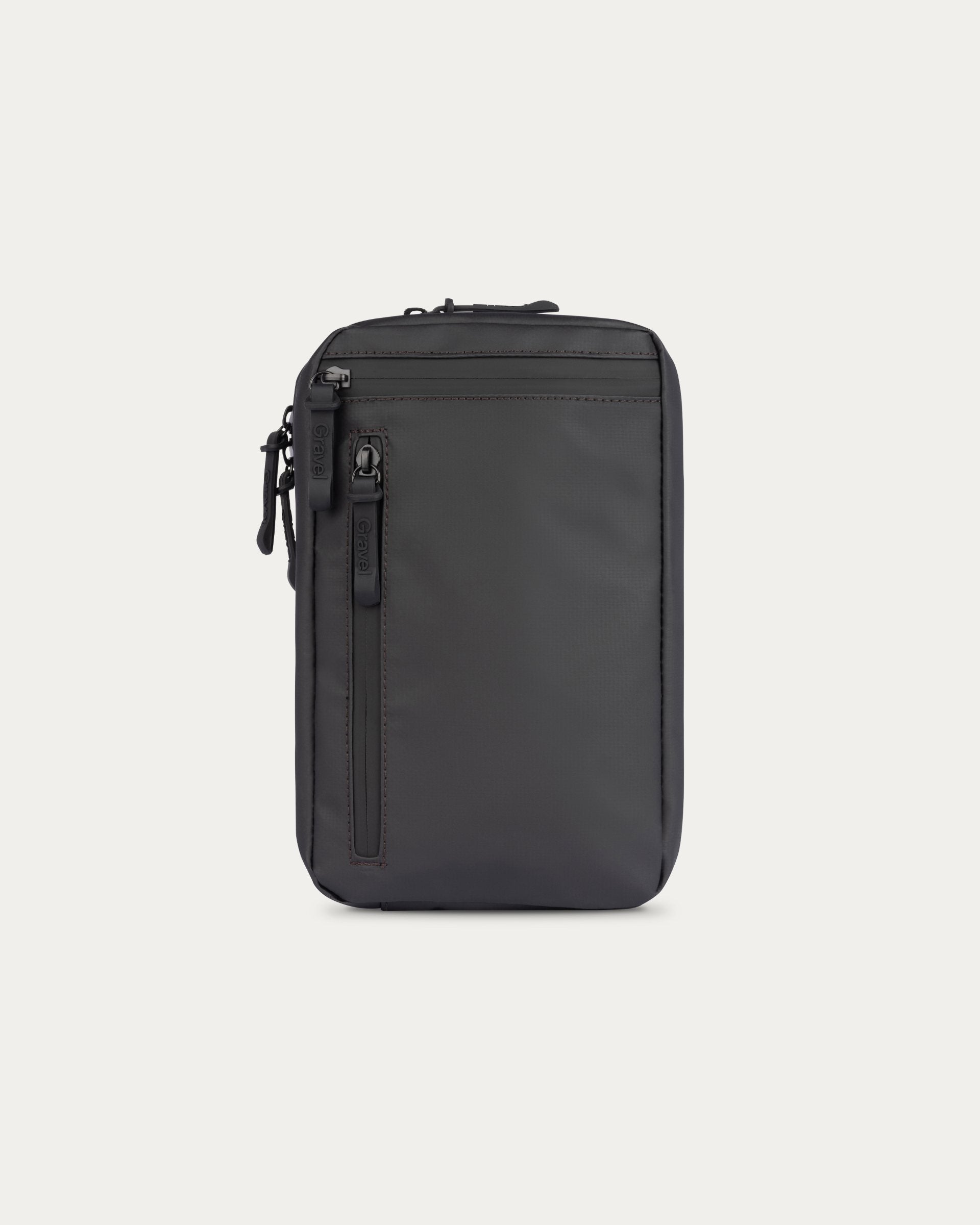 Black travel pouch with zippers on a light gray background