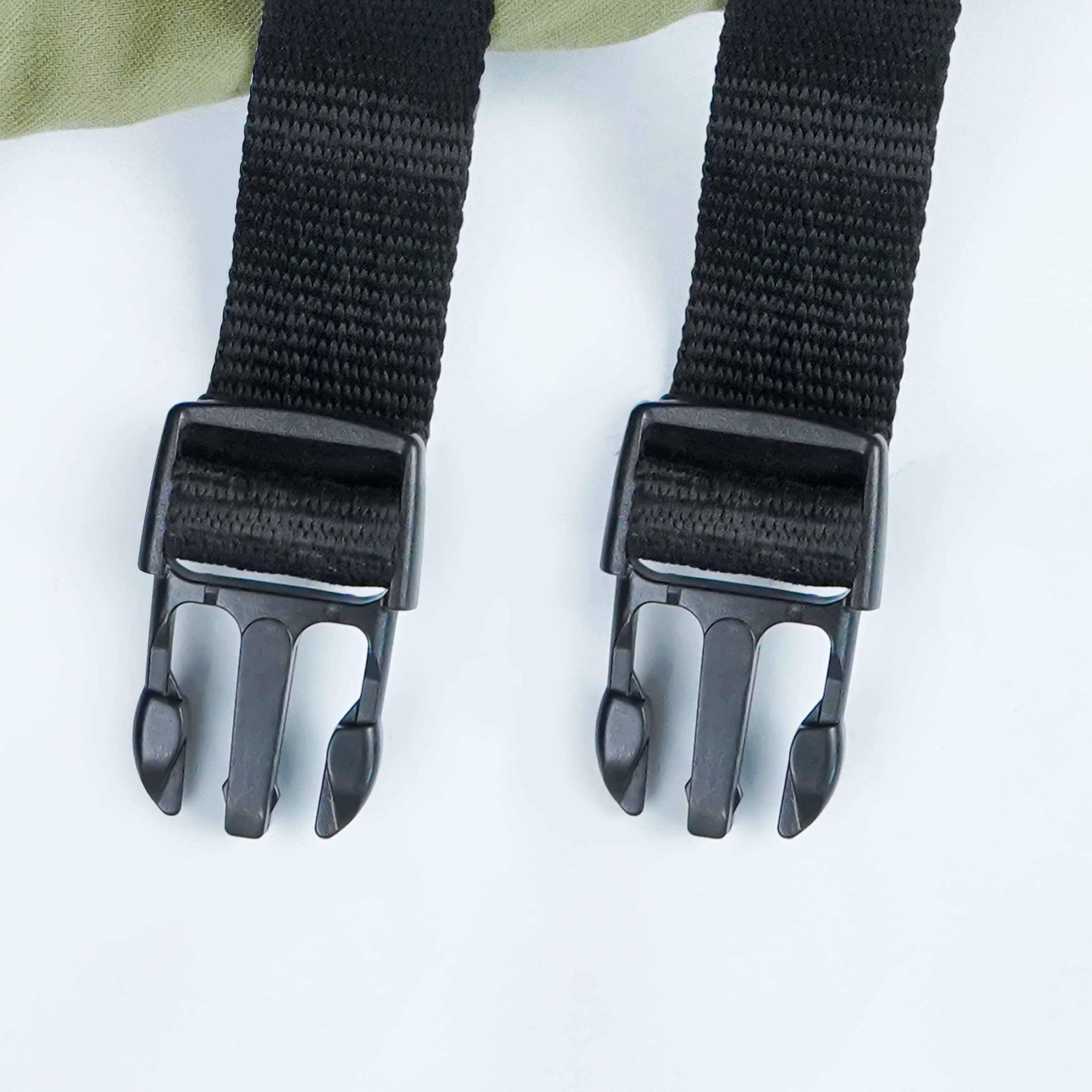 Two black straps with buckles on a white background