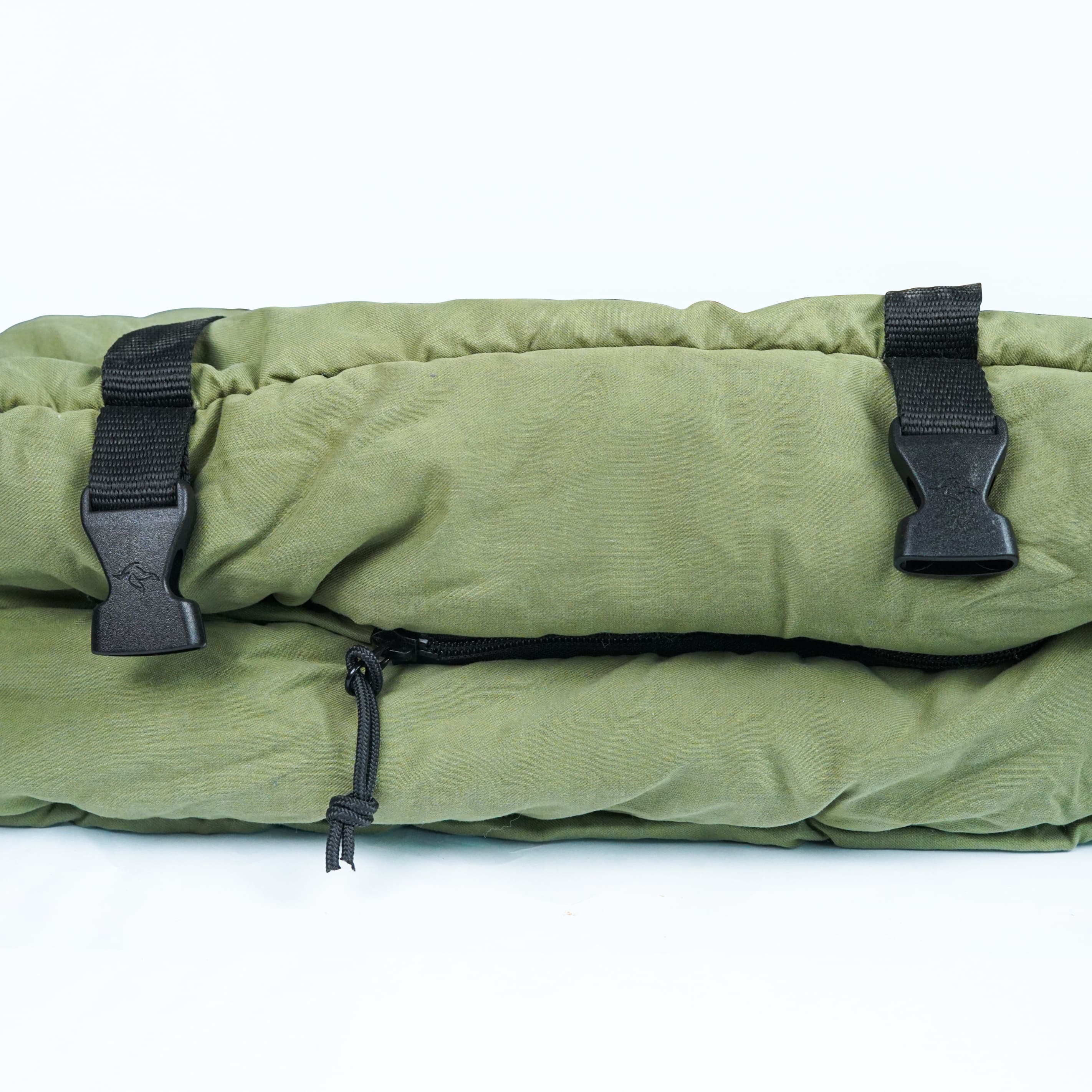 Green sleeping bag with black straps on a white background