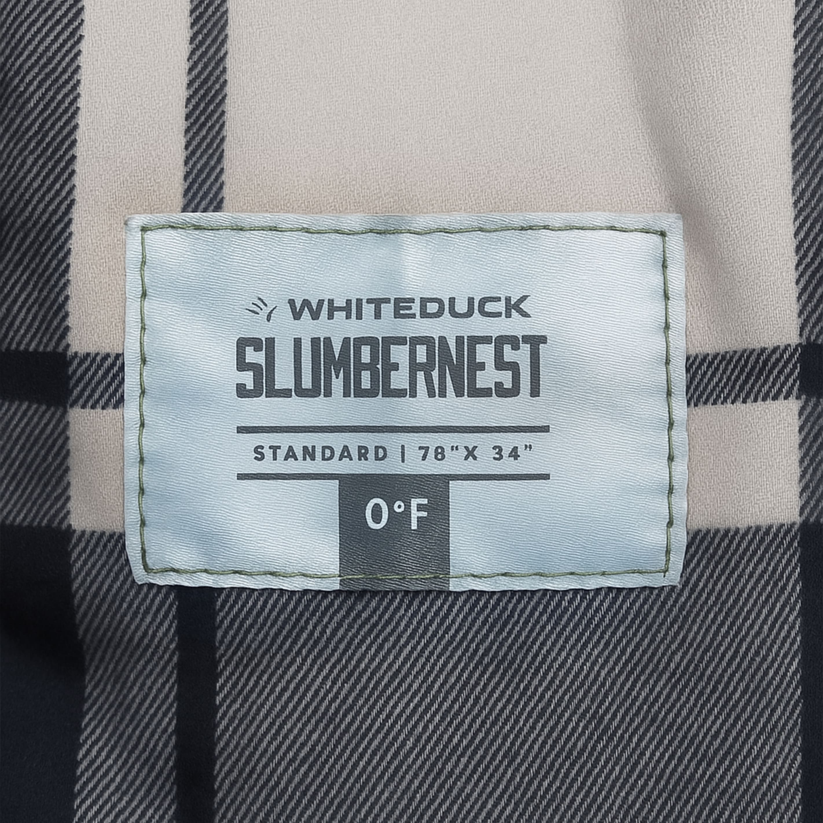 Whiteduck Slumbernest label on a plaid fabric background