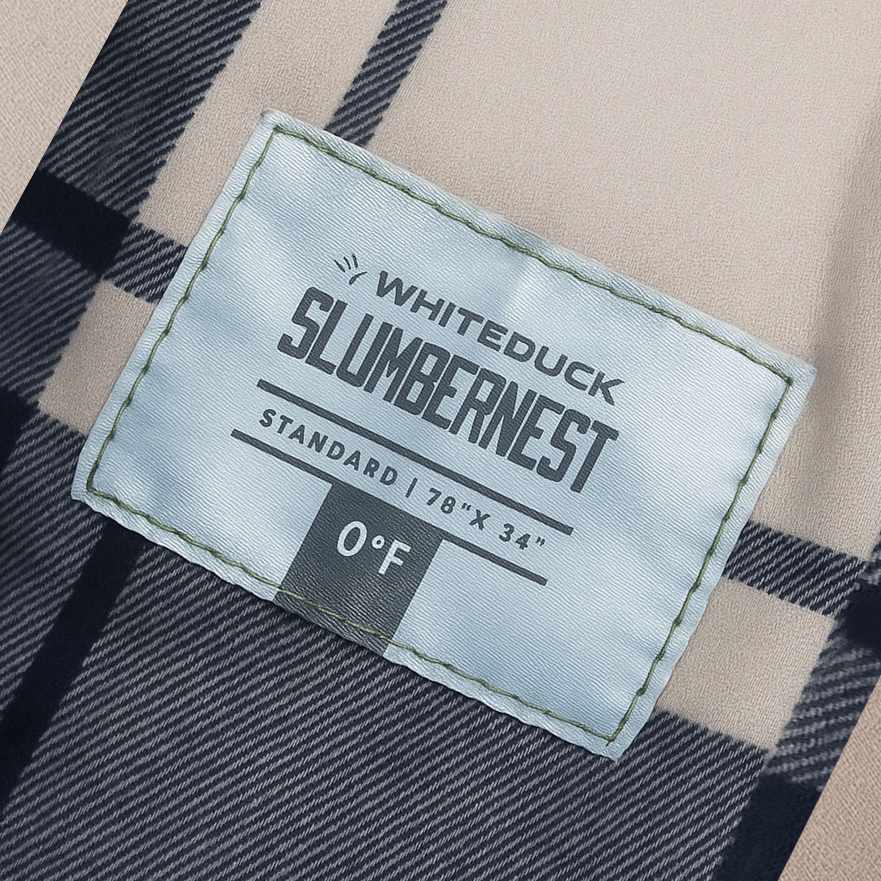 Label on a plaid fabric with 'Whiteduck Slumbernest' branding