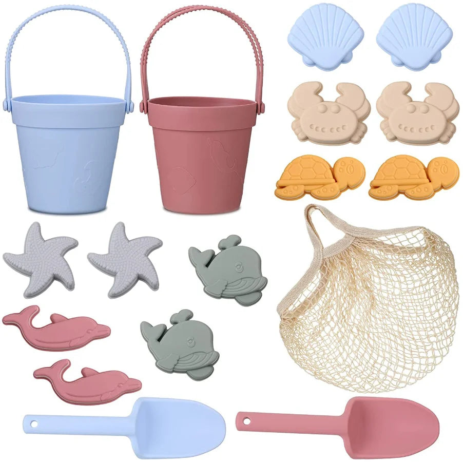 Set of beach toys including buckets, molds, and tools on a white background