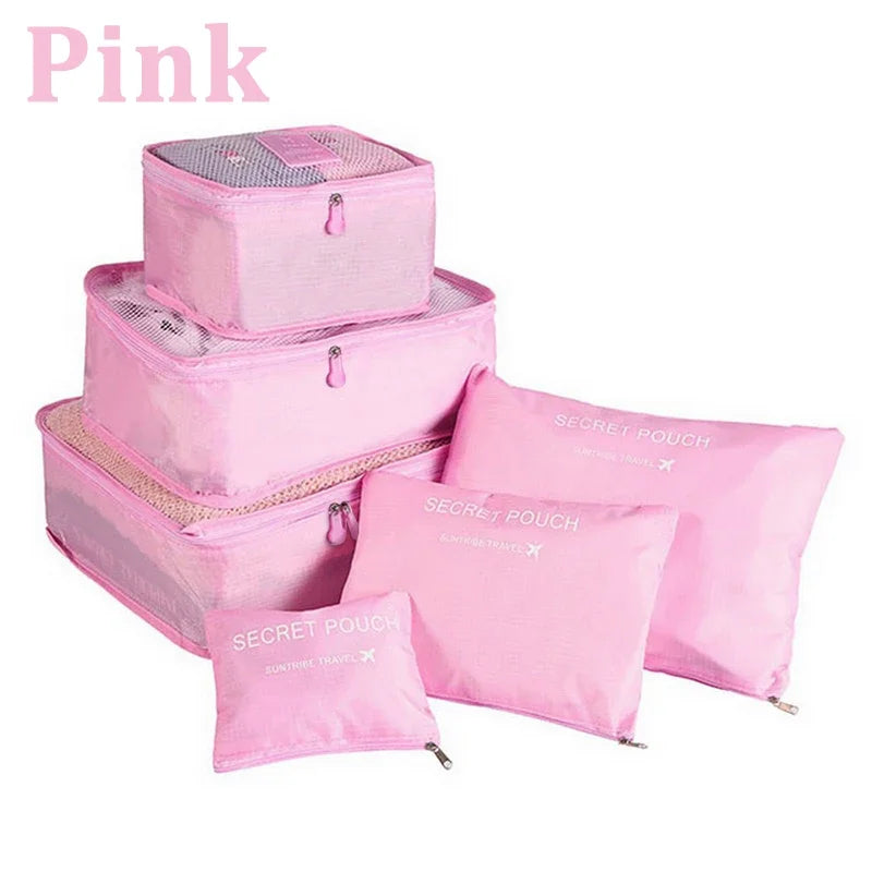 Set of pink packing cubes and pouches with 'Secret Police' branding on a white background.