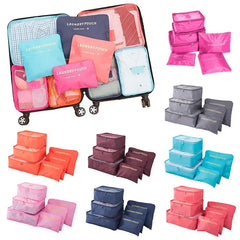 Collection of colorful packing cubes and laundry pouches on a white background