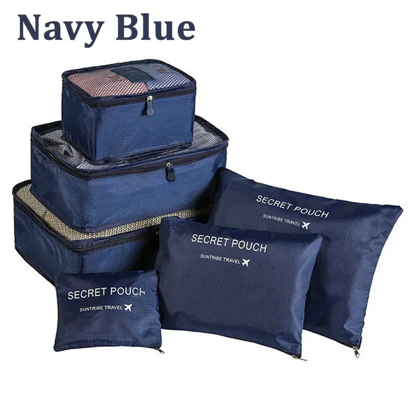 Set of navy blue packing cubes and pouches with 'Secret Pouch' labels on a white background.