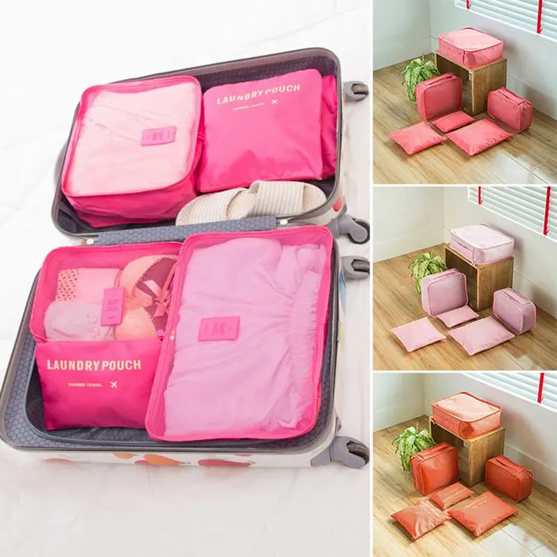 Pink laundry pouches in a suitcase and on a wooden floor.