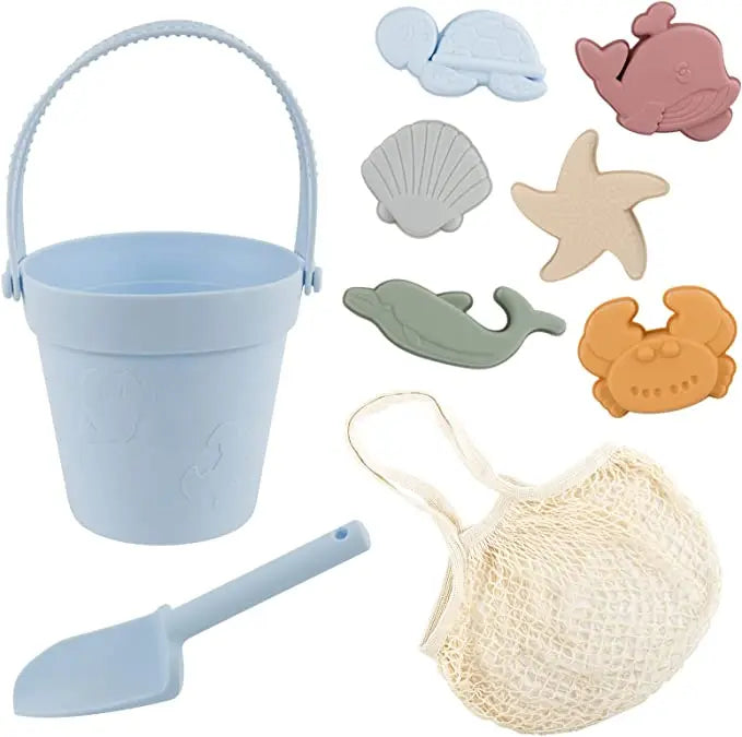 Set of beach toys including a bucket, shovel, net, and sea creature molds on a light background.