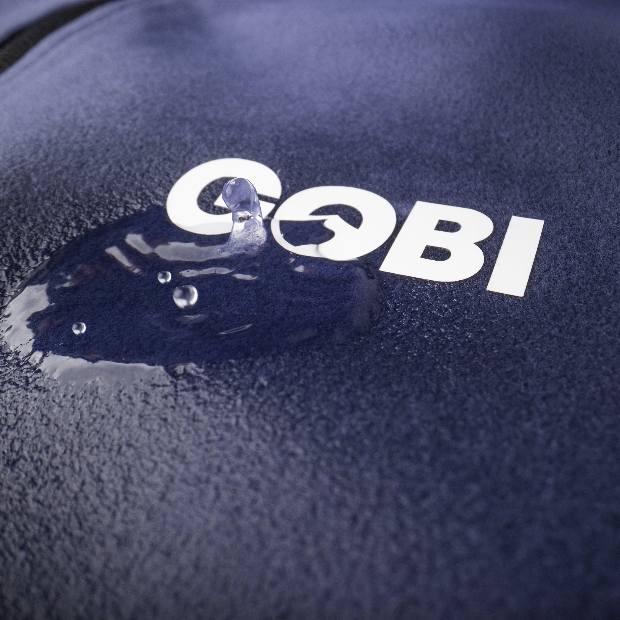 Gobi logo on a textured dark surface with water droplets.