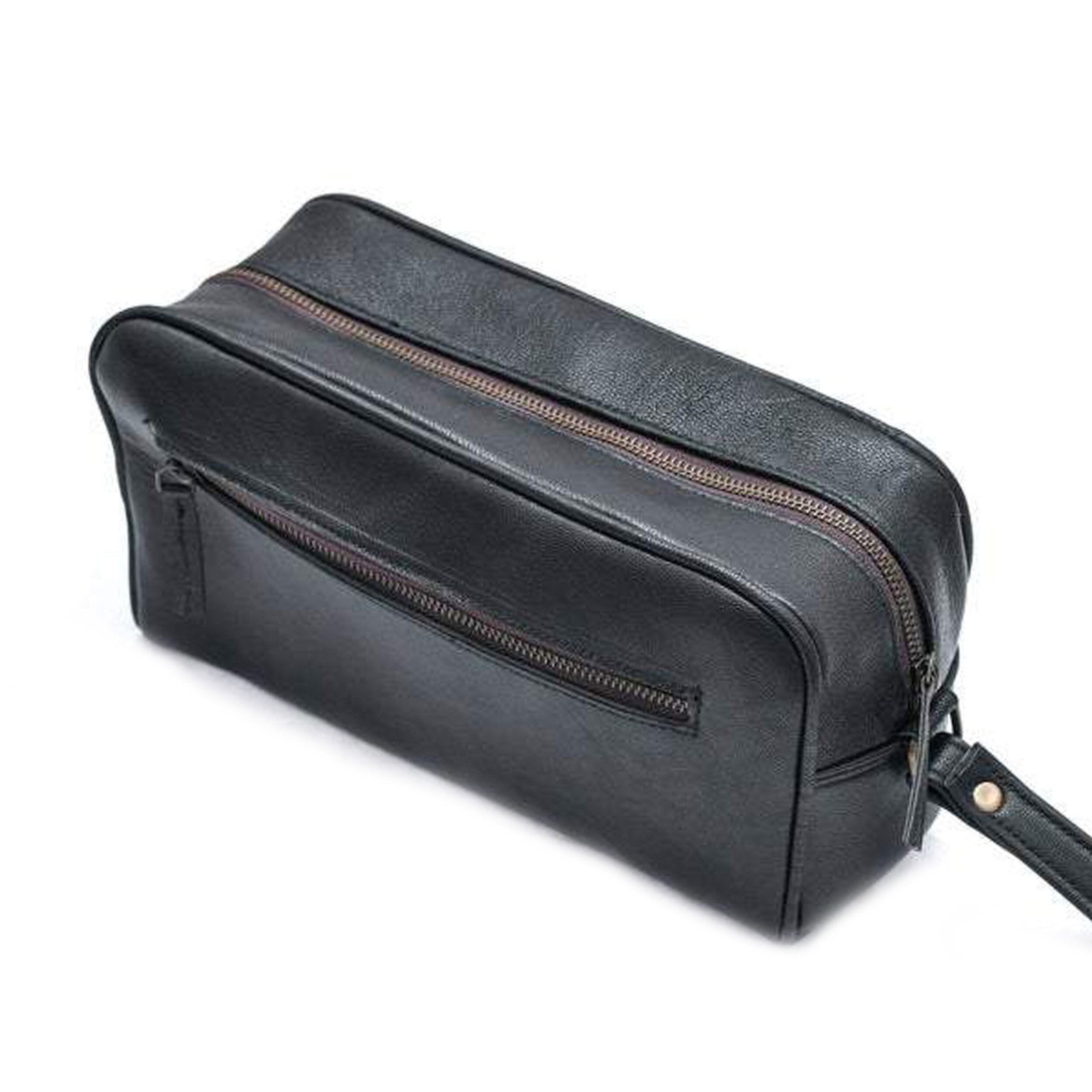Black leather toiletry bag with zipper on a white background