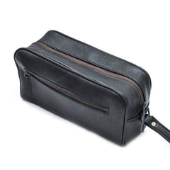 Black leather toiletry bag with zipper on a white background
