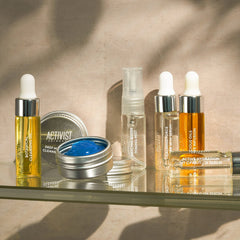 Collection of skincare products on a reflective surface with a neutral background