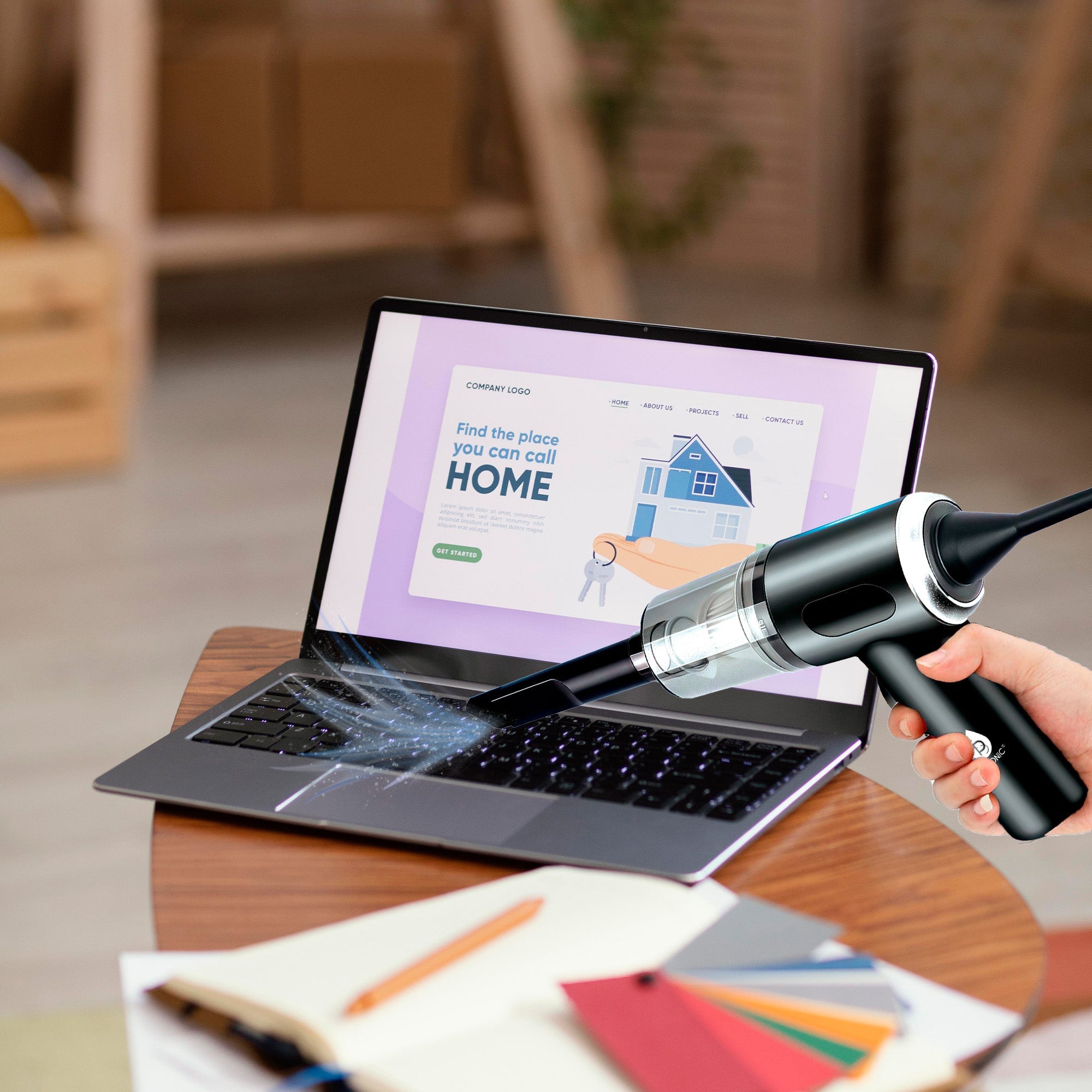 Person using a vacuum cleaner on a laptop screen with a blurred indoor background