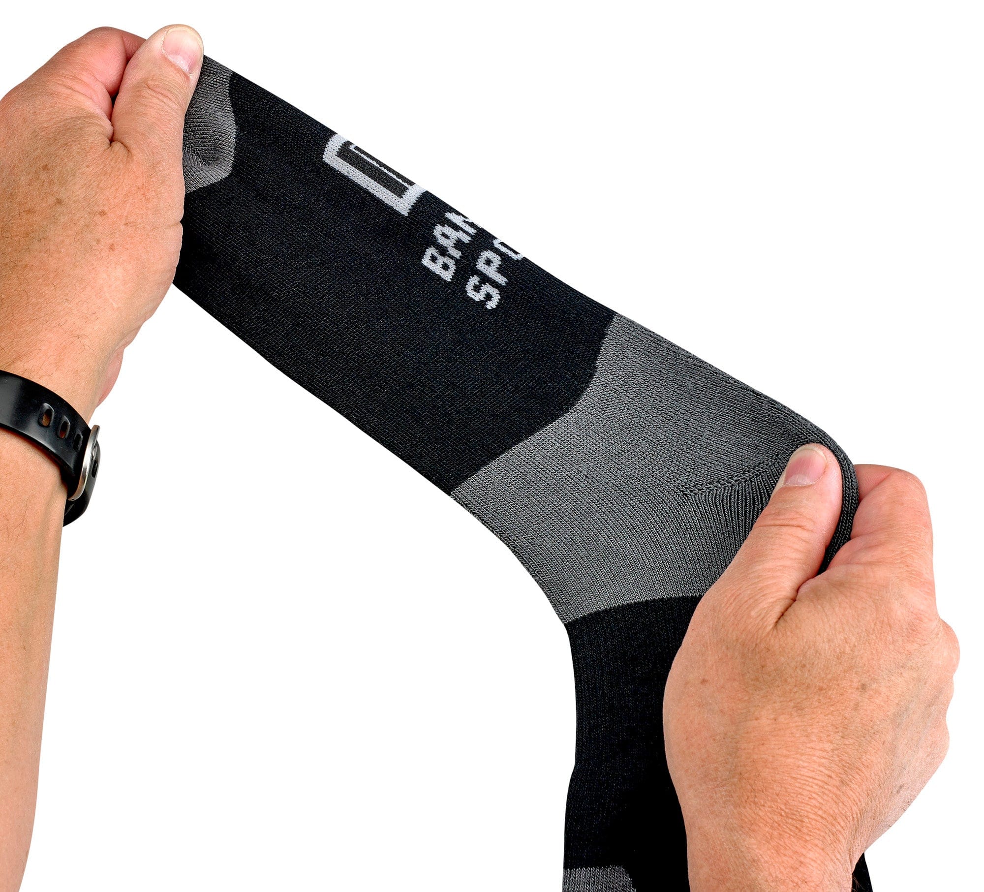 Black and gray sock held by a person's hands on a white background