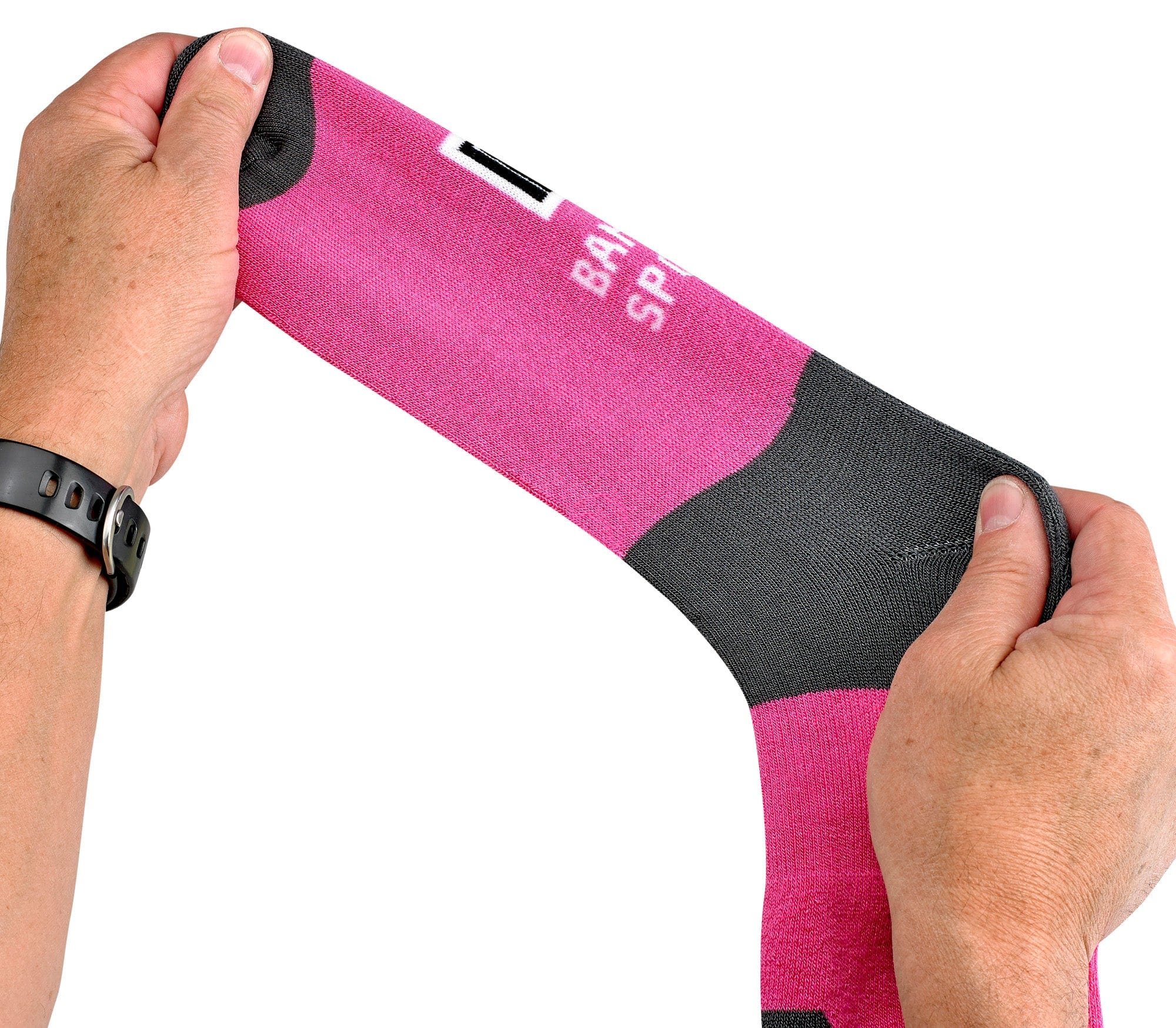 Pink and black arm sleeve with 'Bauer' branding held by a person's hands on a white background