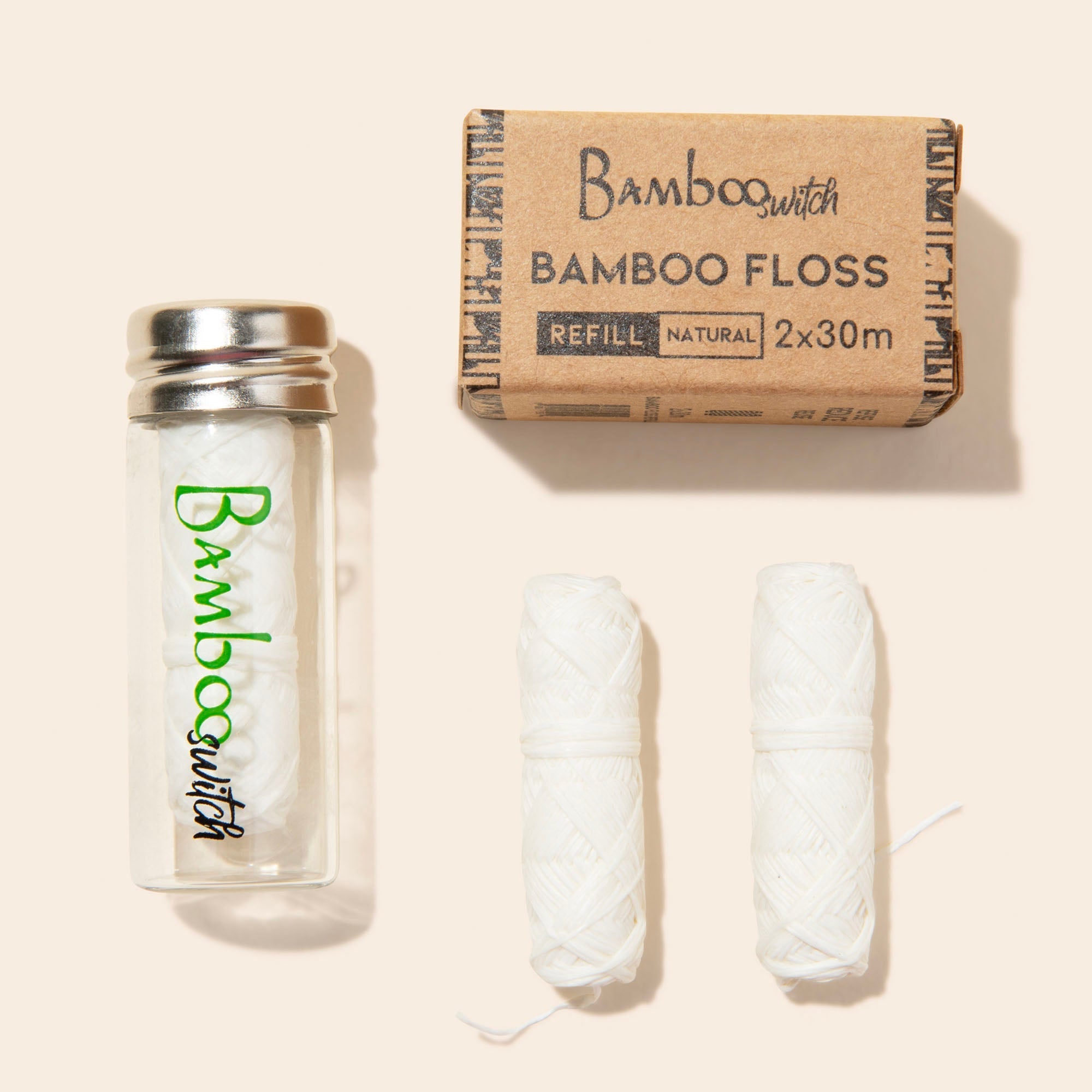 Bamboo Switch bamboo floss set with packaging on a beige background